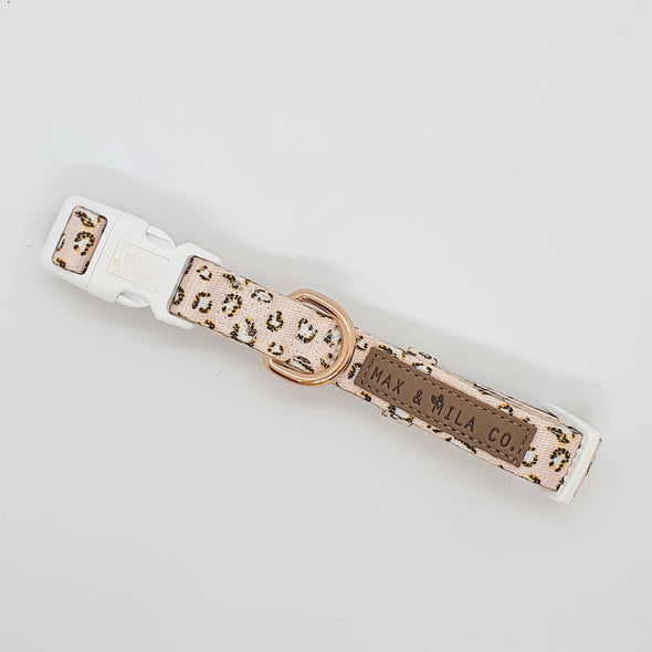 Leopard print dog collar in beige. White plastic buckle with gold hardware.